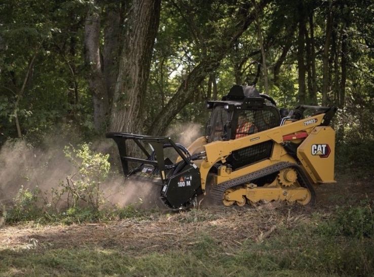 CAT 299D3 XE forestry mulching in a wooded area